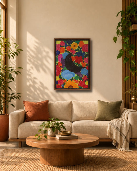 Black moon floral painting in wooden frame hanging above a beige sofa in a warm living room